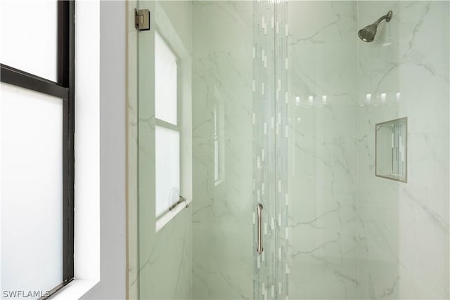 bathroom featuring plenty of natural light and an enclosed shower