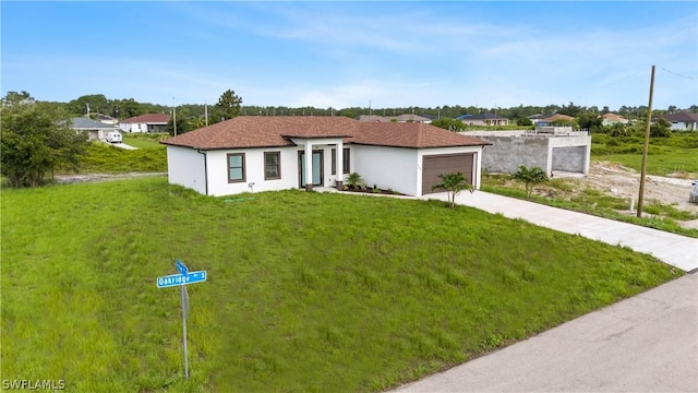 view of front of property with a front yard and a garage