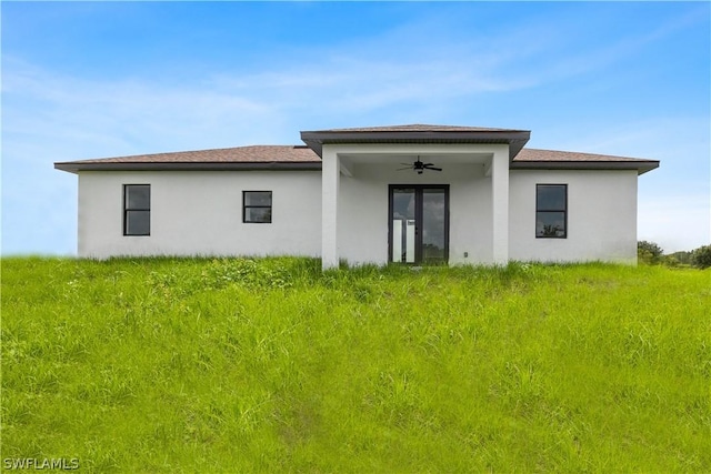 rear view of house featuring ceiling fan