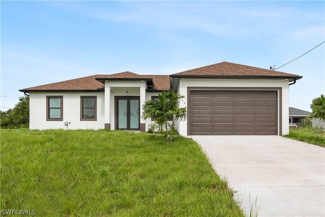 view of front of house with a front yard and a garage