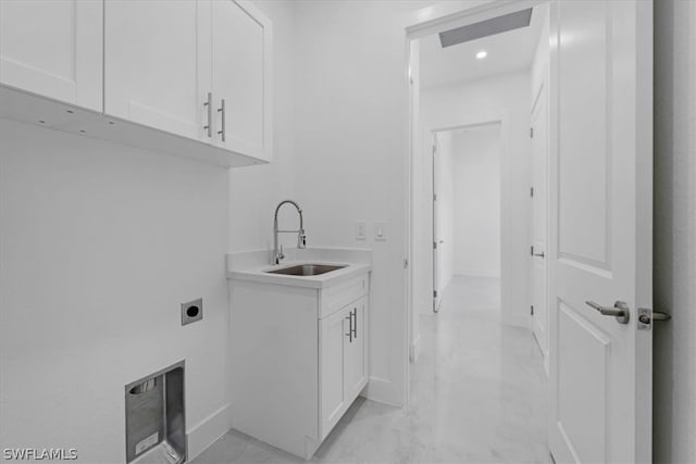 washroom featuring hookup for an electric dryer, cabinets, sink, and light tile flooring