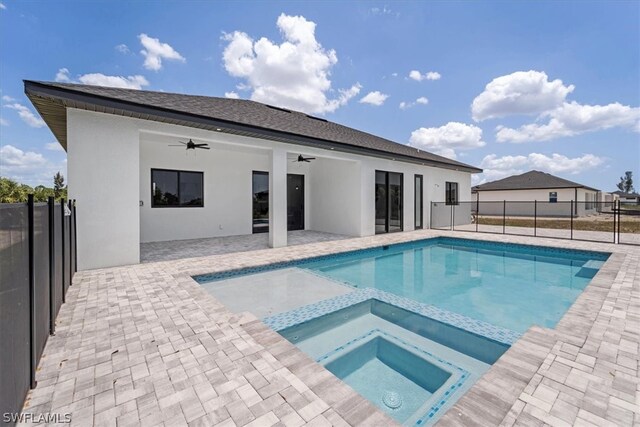 view of pool with a patio area, ceiling fan, and an in ground hot tub