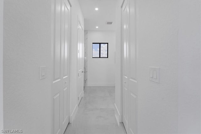 hallway featuring light tile flooring