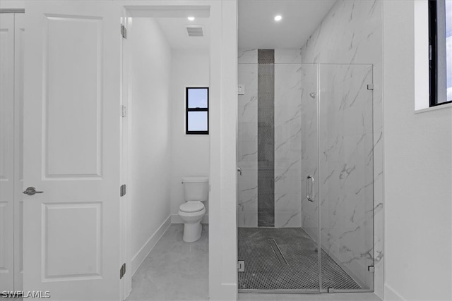 bathroom featuring tile floors, an enclosed shower, and toilet