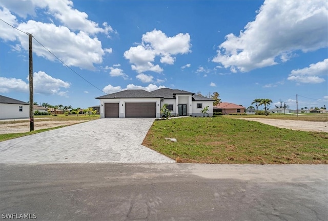 view of front facade with a front yard and a garage