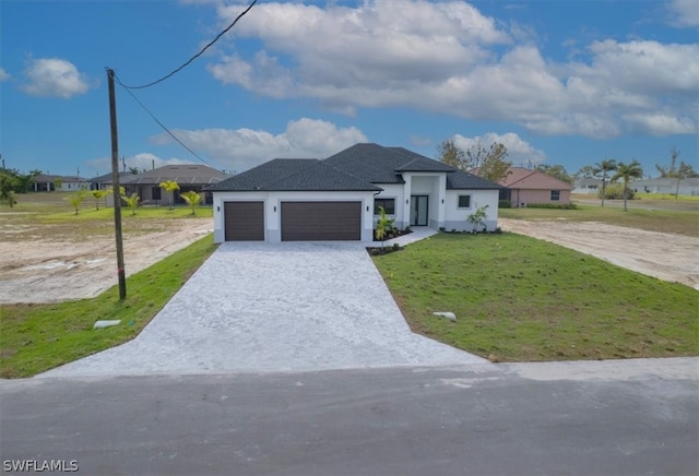 view of front of property with a garage and a front yard