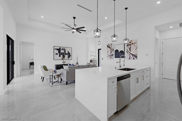 kitchen with white cabinets, sink, dishwasher, a raised ceiling, and decorative light fixtures