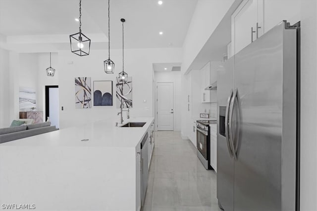 kitchen featuring appliances with stainless steel finishes, light tile floors, white cabinets, sink, and pendant lighting