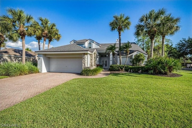 view of front of house with a front yard and a garage