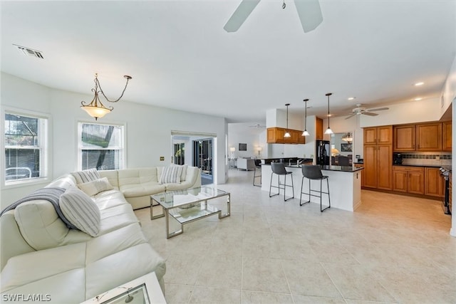 tiled living room with ceiling fan