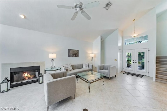 living room with ceiling fan, french doors, light tile patterned floors, and high vaulted ceiling