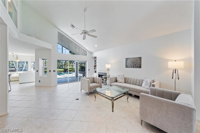 living room featuring ceiling fan, light tile patterned flooring, and high vaulted ceiling