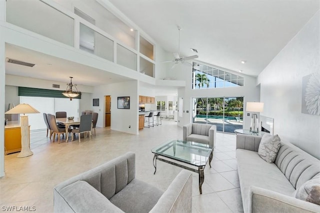 tiled living room featuring high vaulted ceiling and ceiling fan