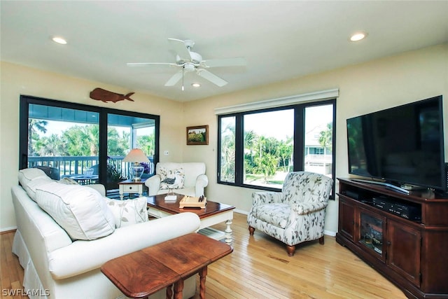 living room with ceiling fan and light wood-type flooring