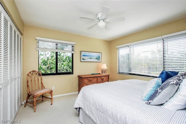 carpeted bedroom with a closet and ceiling fan