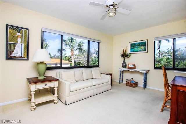 living room with ceiling fan and carpet