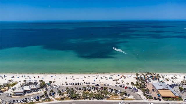 drone / aerial view featuring a water view and a view of the beach