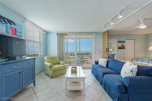 5600 Bonita Beach Rd SW Unit 4606, Bonita Springs, FL 34134 - living area featuring rail lighting, a textured ceiling, ceiling fan, and light tile patterned floors