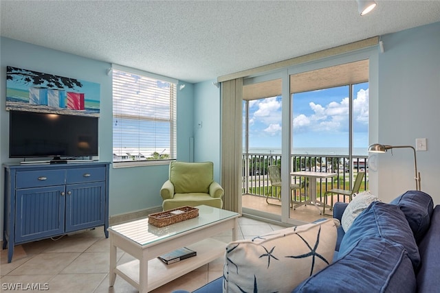 5600 Bonita Beach Rd SW Unit 4606, Bonita Springs, FL 34134 - living area featuring a textured ceiling, a water view, and light tile patterned flooring