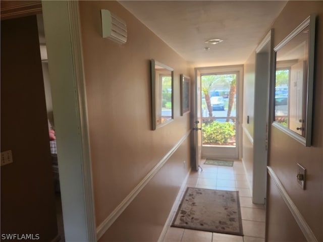 hallway with a wall mounted AC and light tile floors