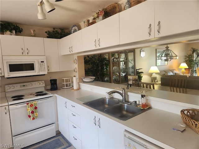 kitchen featuring white cabinets, sink, and white appliances