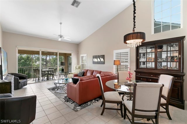 interior space with ceiling fan with notable chandelier and high vaulted ceiling