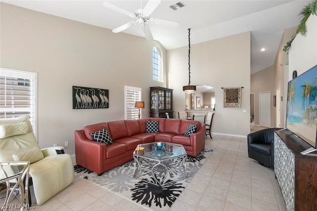 tiled living room featuring high vaulted ceiling and ceiling fan