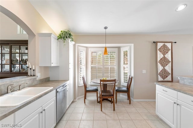 kitchen with stainless steel dishwasher, sink, pendant lighting, and white cabinets