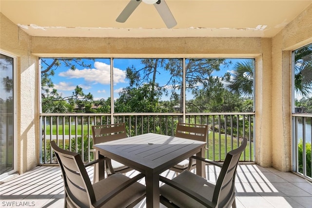 sunroom featuring ceiling fan