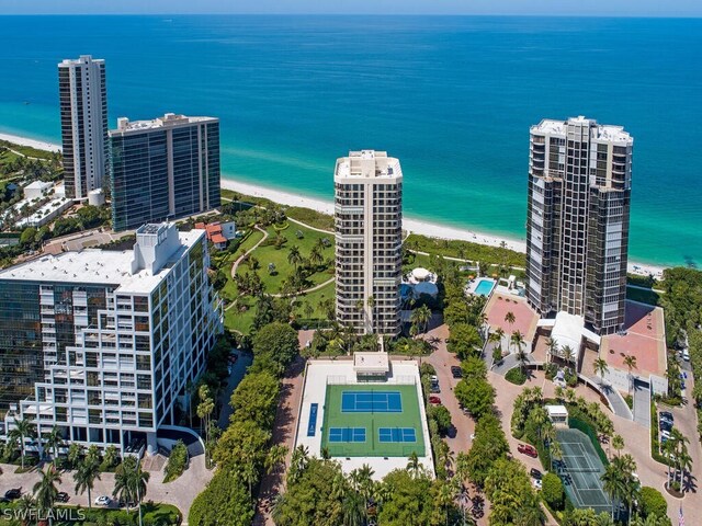 birds eye view of property featuring a water view and a beach view