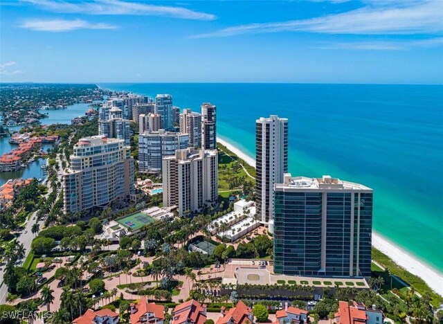 birds eye view of property with a water view and a beach view