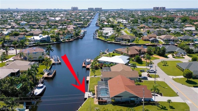 drone / aerial view featuring a water view and a residential view