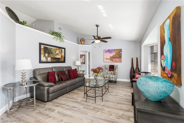 living room with ceiling fan, light hardwood / wood-style floors, and vaulted ceiling