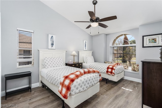 bedroom featuring hardwood / wood-style flooring, ceiling fan, and lofted ceiling