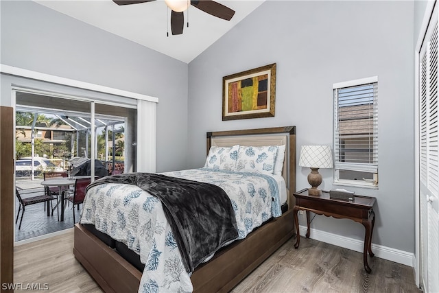 bedroom with access to exterior, vaulted ceiling, ceiling fan, wood-type flooring, and a closet