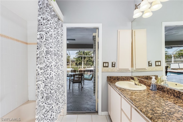 bathroom featuring shower / tub combo, vanity, tile patterned floors, and a healthy amount of sunlight