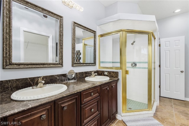 bathroom featuring a shower with door and vanity