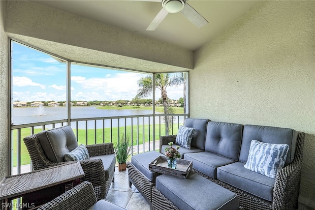 sunroom with ceiling fan, a water view, and a wealth of natural light