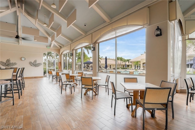 dining area with lofted ceiling, ceiling fan, and light wood-type flooring