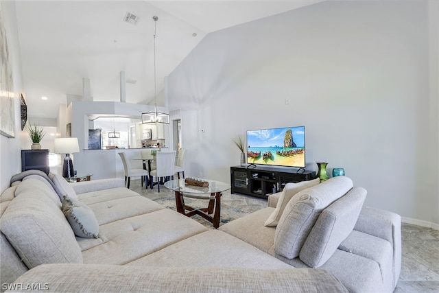 living room with high vaulted ceiling and tile floors