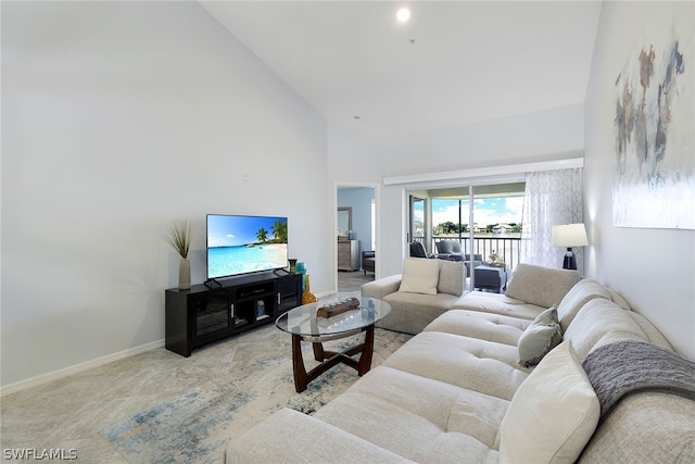 living room featuring high vaulted ceiling