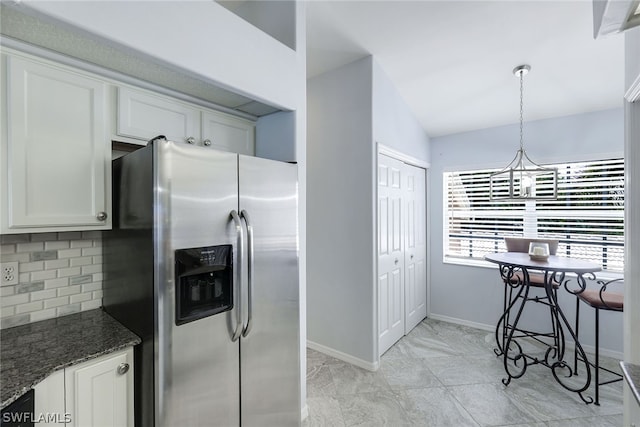 kitchen with light tile floors, tasteful backsplash, white cabinetry, dark stone counters, and stainless steel refrigerator with ice dispenser