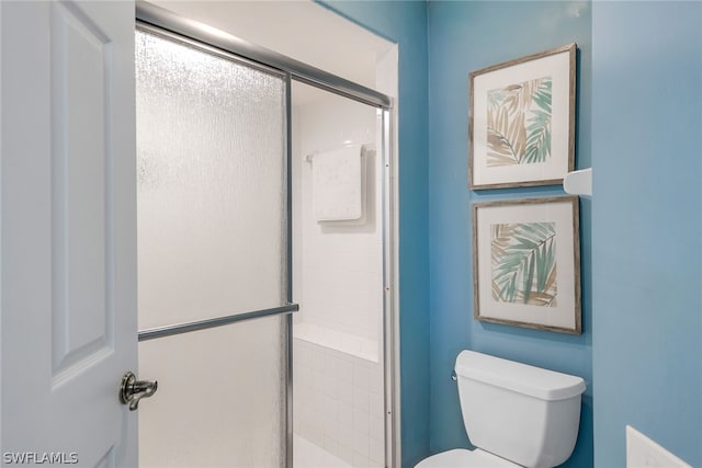 bathroom featuring walk in shower and toilet