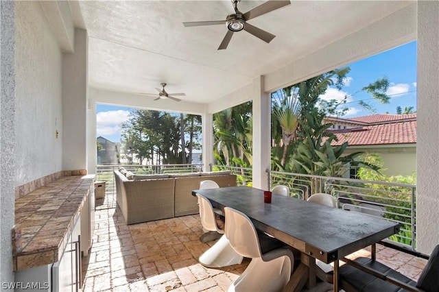 view of patio / terrace with ceiling fan and a balcony