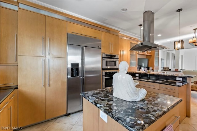 kitchen with island exhaust hood, pendant lighting, stainless steel appliances, and dark stone counters