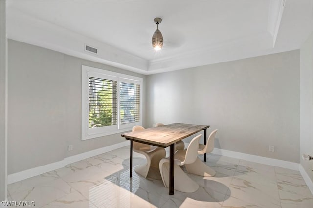 dining room featuring a raised ceiling