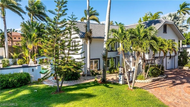 mediterranean / spanish-style house featuring a front yard