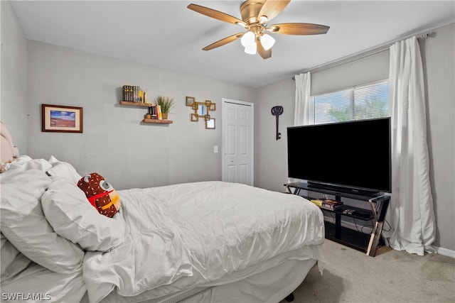 bedroom with carpet floors, ceiling fan, and a closet