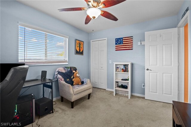 carpeted office featuring ceiling fan