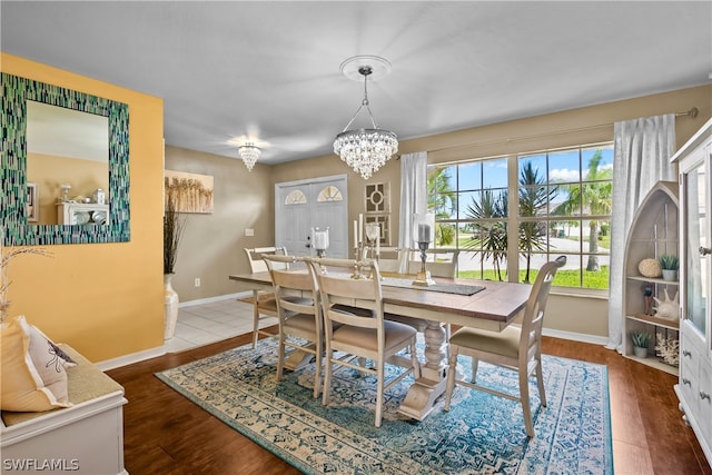 dining room with hardwood / wood-style flooring and a chandelier